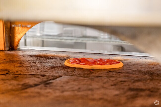 Firepit Pizza Tavern specializes in fire roasted handmade pizzas, and more!