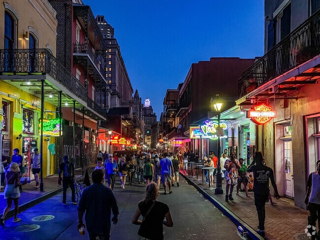 People enjoying the nightlife of Bourbon Street in the French Quarter neighborhood.