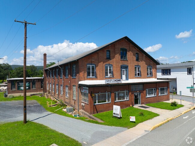 Historic factory buildings have been renovated and now house local businesses.