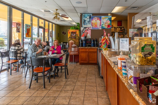 Neighbors enjoy an early morning coffee at Cafe Latte Co. in Galt.
