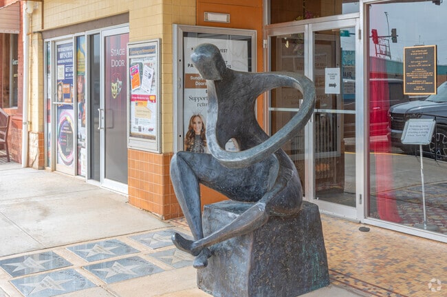In front of the Woodward Theater sits a statue title 