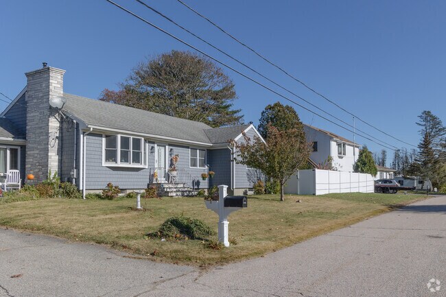 A row of homes in Tiverton's Bliss Corners shows post-war suburban styles.