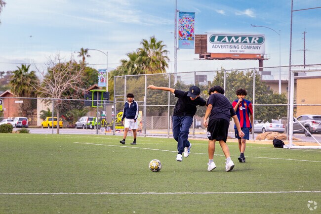 Kids enjoy a beautiful day playing soccer at Rafael Rivera Park.