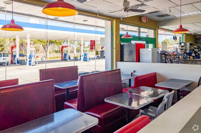 Interior dining seating overlooking gas station at Saffron Indian Cusine.