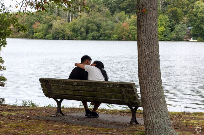 Sit on a bench and take in the beauty at Sunset Lake Park.