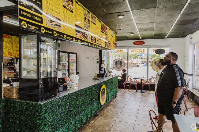 Locals peruse the extensive menu at El Rucon restaurant in Golfview Heights.