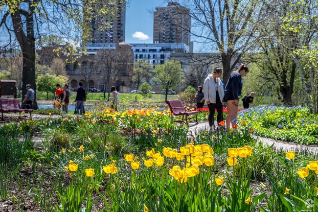 Park goers head to Loring Park for the gardens and flowers along the walking trails.