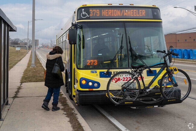A passenger ready to board a bus in the quiet neighborhood of Justice, IL.