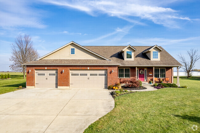 Contemporary cape code home in Turtle Creek Township features a beautiful front yard.