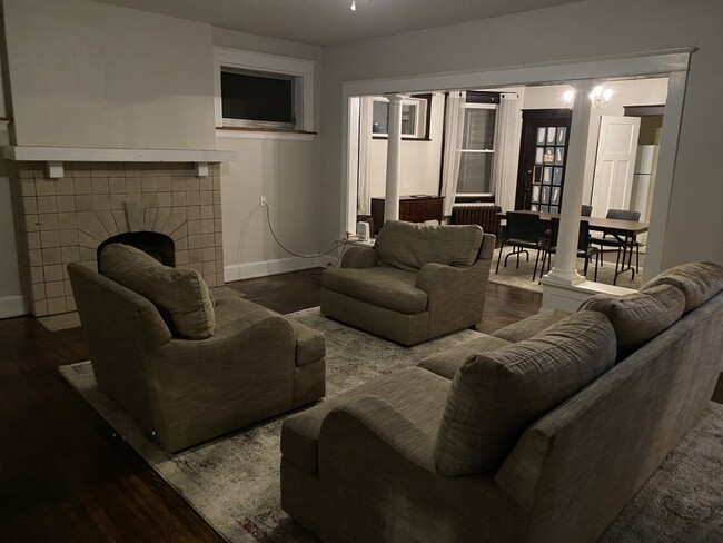 large dinning room, living room, comes with rug and couches, table and chairs.