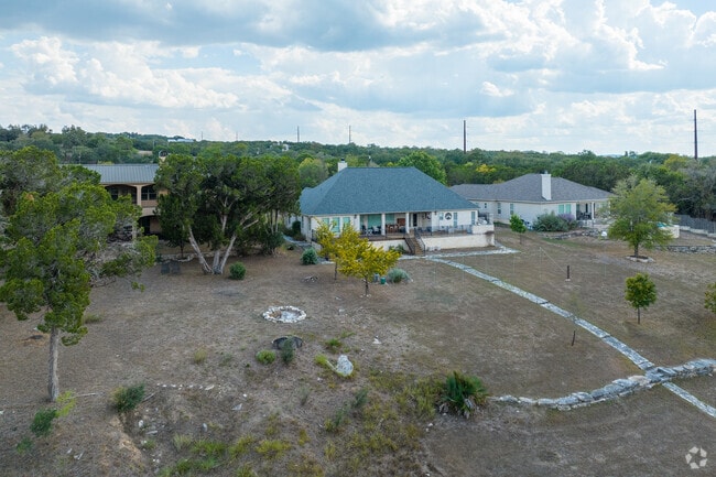 Three riverside houses in Wimberley, Texas, perfectly poised along the tranquil Blanco River.