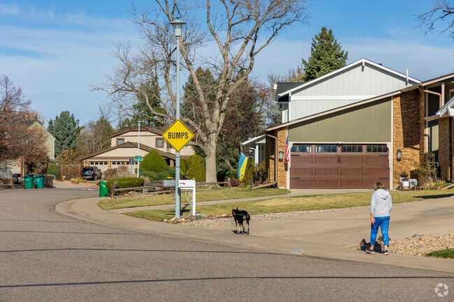 A resident in the Columbine Knolls South II neighborhood takes her dog for an afternoon walk.