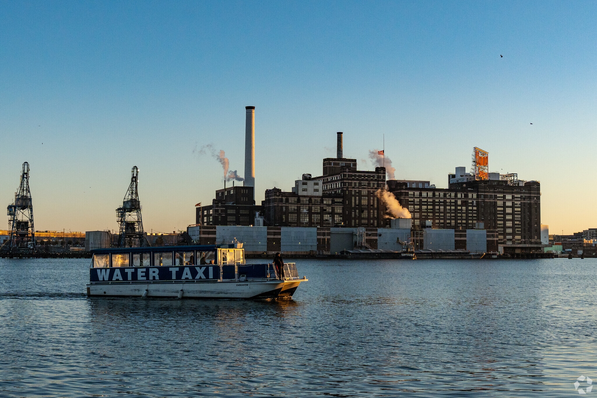 Water Taxi crossing the bay in Fells Point at sunset allows visitors to see the full city.