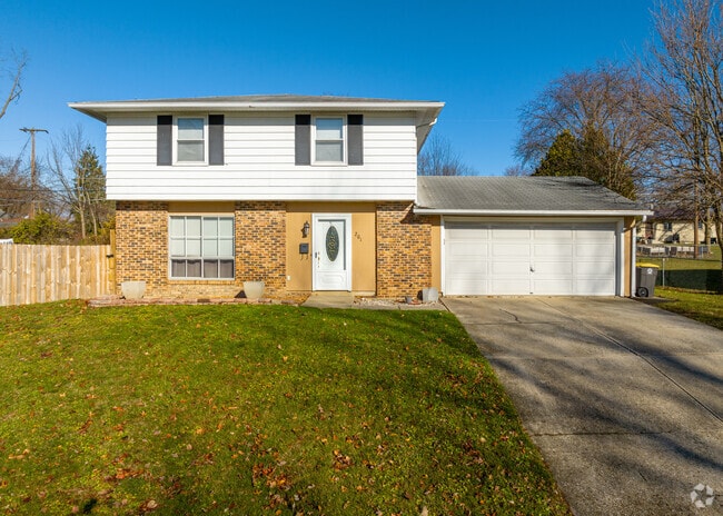 A raised ranch-style home in Morningside-Terrace, Fort Wayne, with a fenced-in backyard.