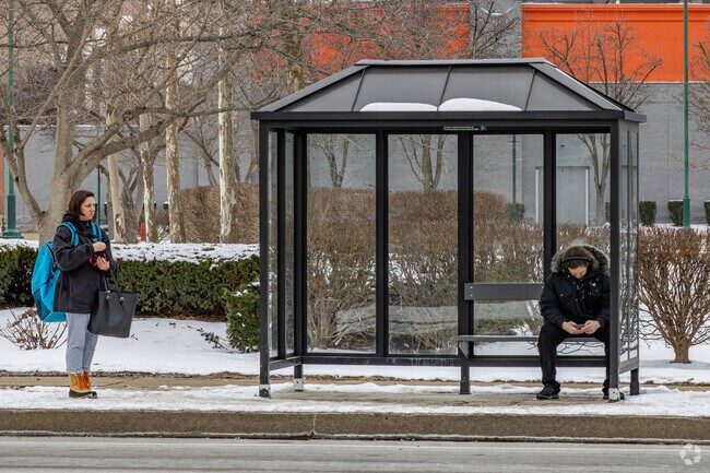 Some bus stops have seating so folks can take a load off while they wait.