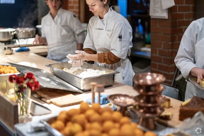 The kitchen at Chez Panisse is bustling with food prep for awaiting patrons upstairs.