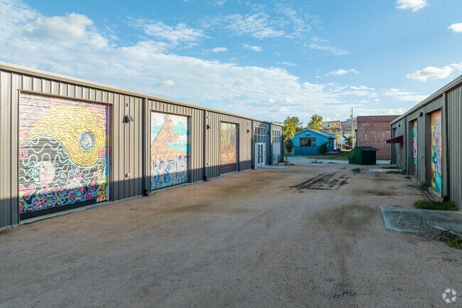 Colorful murals paint the bay doors of the Downtown Convention Center in Mills.