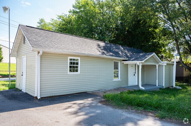 A ranch style home with beige siding and a small front yard.