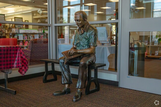 Encounter the book-reading statue at Lebanon Junction's local library.