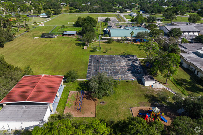 The Alva School has athletic courts and playgrounds behind the school building.