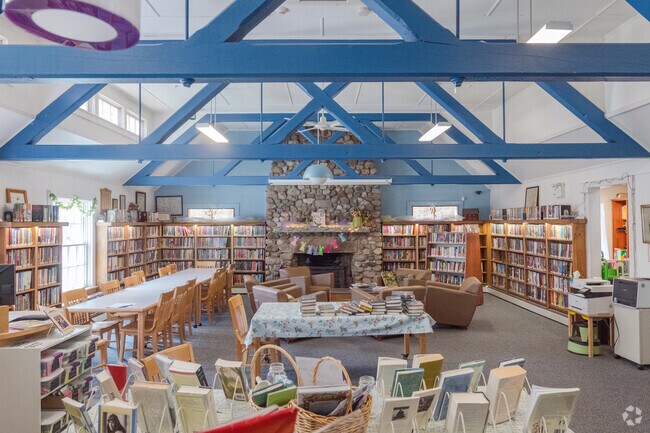 The Greene Library is housed in an historic building with exposed rafters.