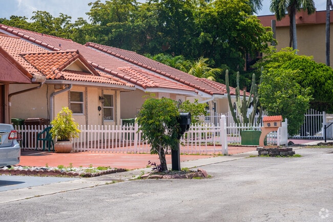 A row of smaller single-family homes with terracotta roofing in Hialeah Gardens, FL.