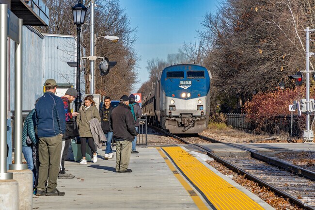 Westford passengers wait as an Amtrak train pulls into the station, bringing a burst of energy to this otherwise quiet New England morning.