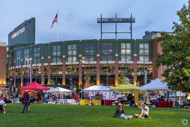 The Titletown Night market glows in the shadow of Lambeau in the summer.