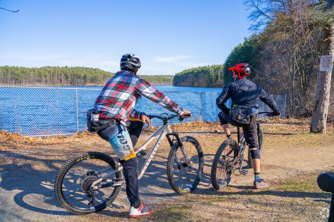 Bikers take a break to embrace the reservoir views while riding the trails at the Middlesex Fells Reservation near Lindenwood.