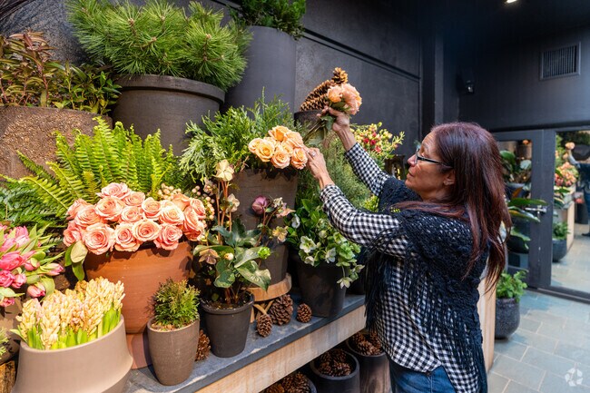 A florist prepares a bouquet at Winston Flowers in Wellesley.