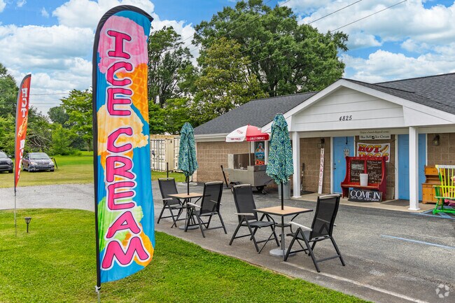 Tables and bright flags invite customers to enjoy ice cream at All in the Family in Browns Summit.