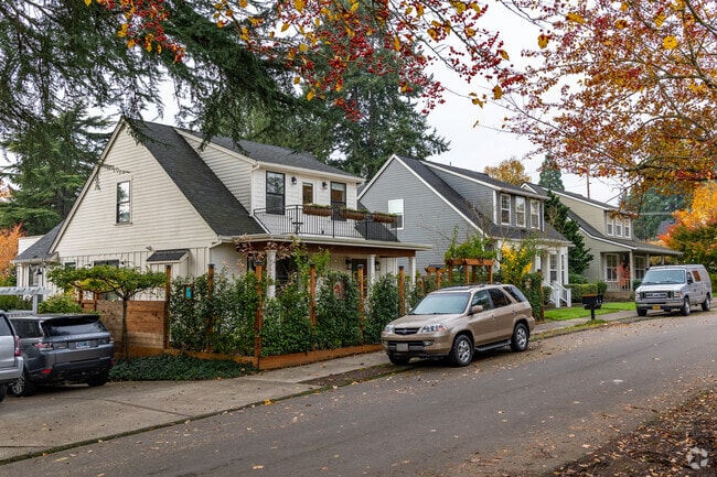 Charming bungalows line the street under vibrant autumn foliage in Foothills.