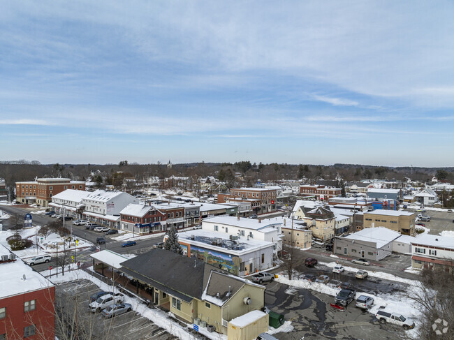 An aerial view of Downtown Derry showcases a blend of of historic charm and modern energy, with bustling streets, local businesses, and a strong sense of community.