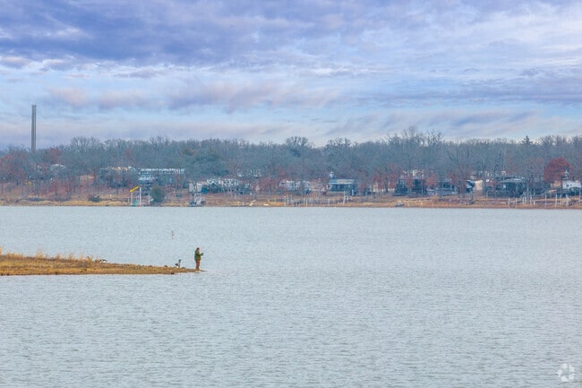 A lone fisherman enjoys a quiet moment on the lake, embracing the peaceful beauty of Stillwater.
