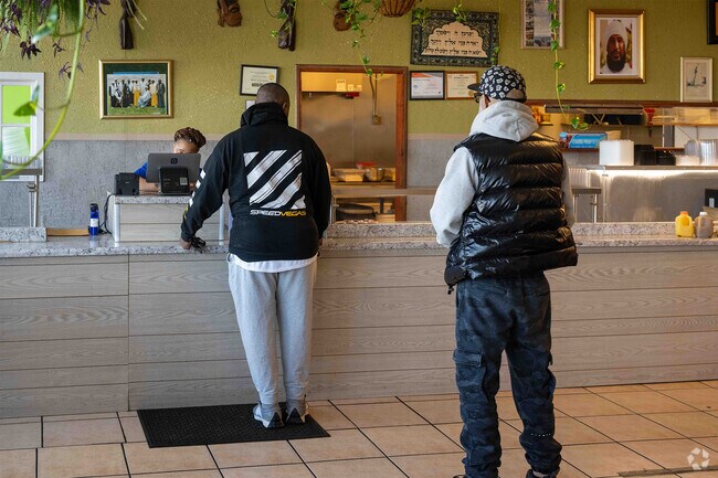 A customer is ordering at Daisy’s Catering Cafe in South Holland near Phoenix, IL.