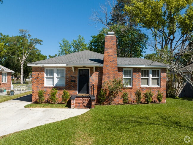 Brick bungalow in Murray Hill with a fireplace.
