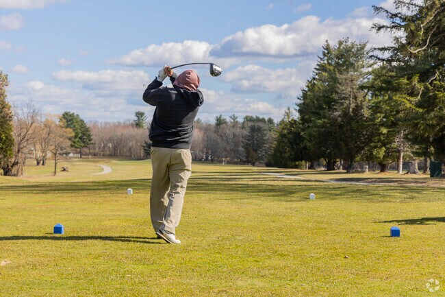 A golfer tees off at the Crystal Lake Country Club near West Parish.