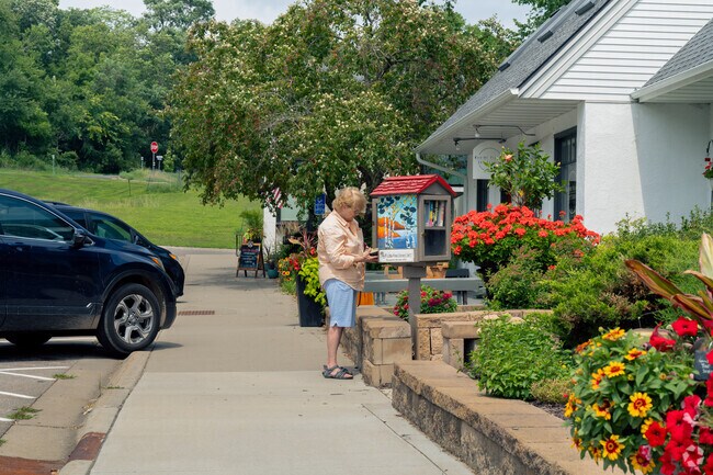 Residents enjoy books at the Little Free Library in front of Edward Jones Financial in downtown.