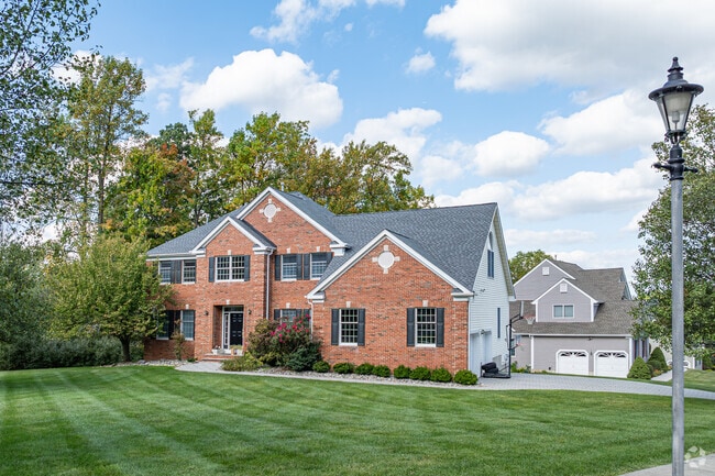 Many homes in The Hills have long front lawns and are shaded by tall trees.