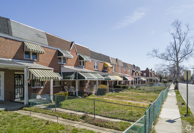 Different colored awnings offer shade for Allendale residents relaxing on their porch.