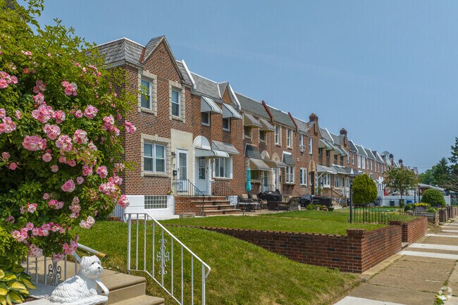 Blossoming roses in front of Tacony rowhomes add a beautiful scent to the city.