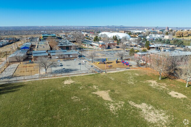 The large grass field and playground found at Lowell Elementary School.