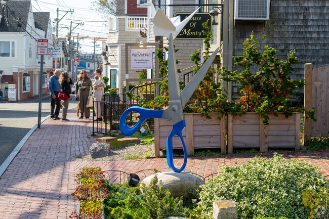 Oversized scissors sculpture anchors a brick walkway in downtown Provincetown.