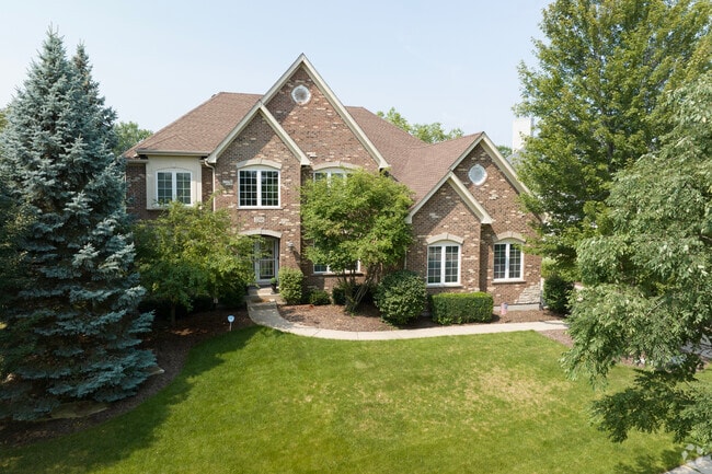 Large brick homes in Nelson Lake sit back from the street with privacy and old shrubs for shade.