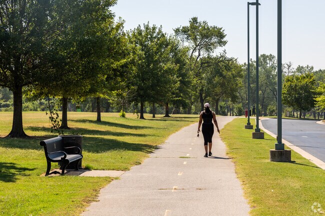 A person finds serenity while walking along a peaceful trail in the heart of Sand Springs.