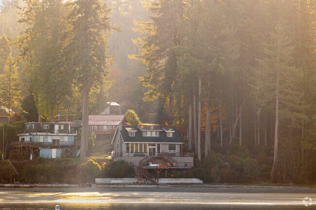 Beach homes sit along the coast of Home in the morning light.