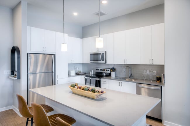 Scheme 1 kitchen with quartz countertops, tile backsplash, stainless steel appliances and hard surface flooring