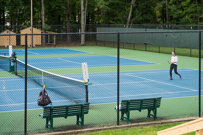 Sleepy Hollow residents catch up over a match of tennis.
