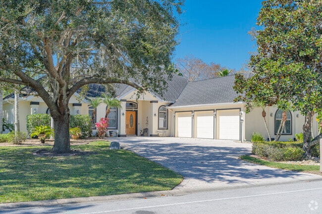 This Sugar Mill home has room for all your toys in the three-car garage.