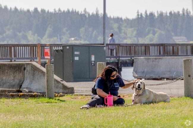 Grab a seat in the grass with your best friend at Silverdale Waterfront Park in Silverdale.